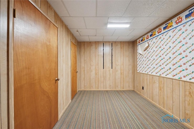 17715 Mitchell Rd, Bowling Green, OH 43402 - empty room with wood walls, carpet floors, and a drop ceiling