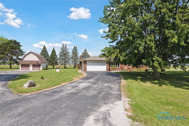 17715 Mitchell Rd, Bowling Green, OH 43402 - view of front of property featuring a front yard and brick siding