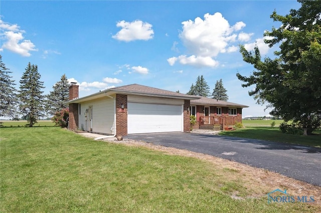 17715 Mitchell Rd, Bowling Green, OH 43402 - ranch-style house featuring a chimney, an attached garage, a front yard, and brick siding