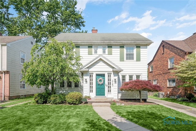 3743 Woodmont Rd, Toledo, OH 43613 - view of front of house with a chimney and a front lawn