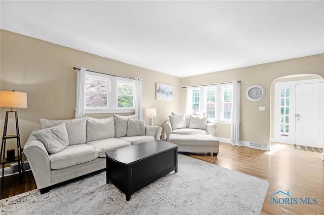 3743 Woodmont Rd, Toledo, OH 43613 - living room featuring arched walkways and wood finished floors