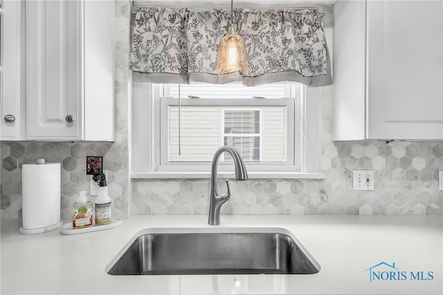 3743 Woodmont Rd, Toledo, OH 43613 - kitchen with white cabinets, backsplash, and light countertops