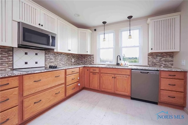 12044 W Duff Washa Rd, Oak Harbor, OH 43449 - kitchen featuring appliances with stainless steel finishes, light stone counters, backsplash, decorative light fixtures, and white cabinetry