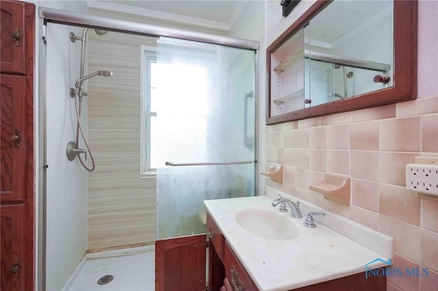 12044 W Duff Washa Rd, Oak Harbor, OH 43449 - full bath featuring a stall shower, ornamental molding, healthy amount of natural light, vanity, and tile walls