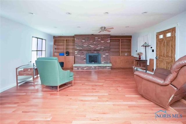 12044 W Duff Washa Rd, Oak Harbor, OH 43449 - living room with a ceiling fan, a fireplace, light wood finished floors, built in features, and recessed lighting