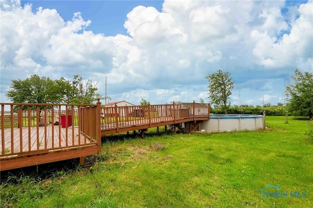 12044 W Duff Washa Rd, Oak Harbor, OH 43449 - view of grassy yard featuring a wooden deck and an outdoor pool