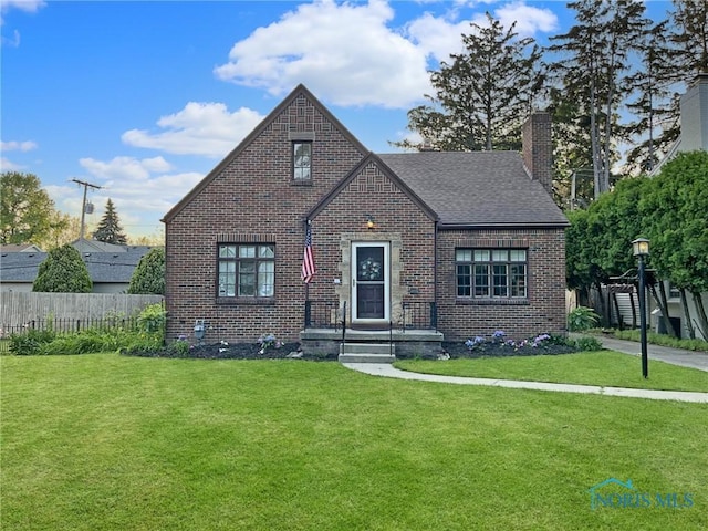 3740 Mapleway Dr, Toledo, OH 43614 - tudor home featuring brick siding, a chimney, and a shingled roof