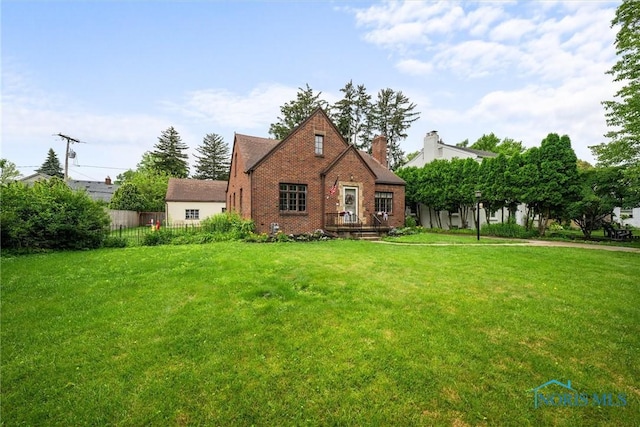 3740 Mapleway Dr, Toledo, OH 43614 - view of front of house with brick siding, a chimney, and a front lawn