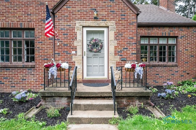 3740 Mapleway Dr, Toledo, OH 43614 - property entrance featuring brick siding, a chimney, and a shingled roof