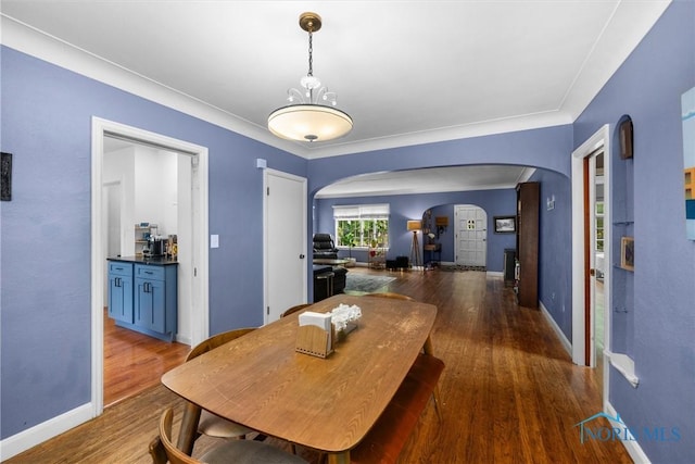 3740 Mapleway Dr, Toledo, OH 43614 - dining space with arched walkways and wood finished floors