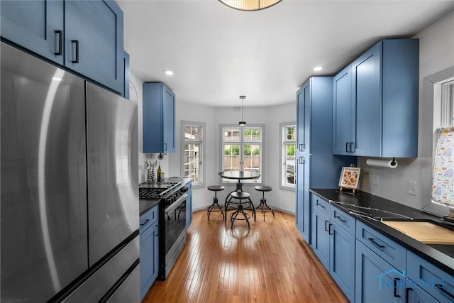 3740 Mapleway Dr, Toledo, OH 43614 - kitchen with stainless steel appliances, blue cabinets, dark countertops, and recessed lighting