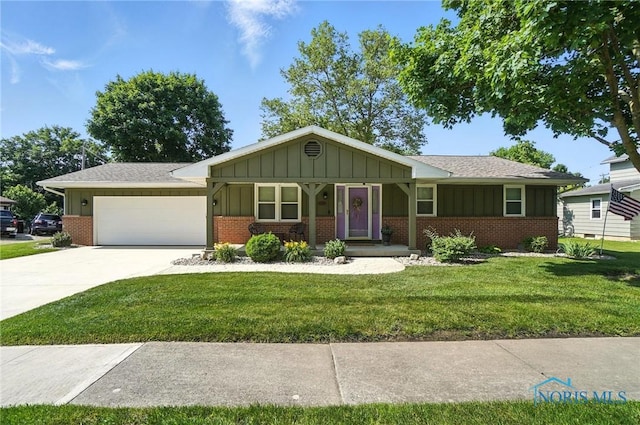 24356 W 3rd St, Grand Rapids, OH 43522 - ranch-style house featuring brick siding, board and batten siding, a front yard, an attached garage, and driveway