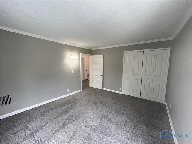 4032 Burnham Ave, Toledo, OH 43612 - unfurnished bedroom featuring ornamental molding, dark carpet, and a closet
