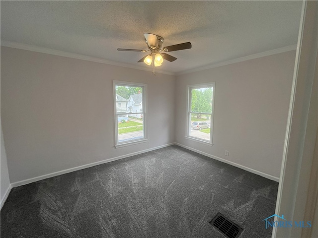 4032 Burnham Ave, Toledo, OH 43612 - empty room with healthy amount of natural light, ornamental molding, dark colored carpet, ceiling fan, and a textured ceiling