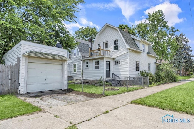 826 4th St, Toledo, OH 43605 - dutch colonial featuring a gambrel roof, a fenced front yard, a balcony, asphalt driveway, and a shingled roof