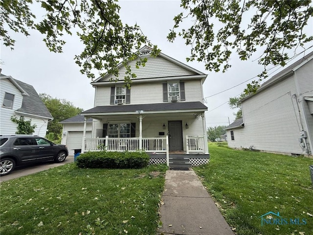 952 Post St, Toledo, OH 43610 - victorian home with a porch, a front yard, and a garage