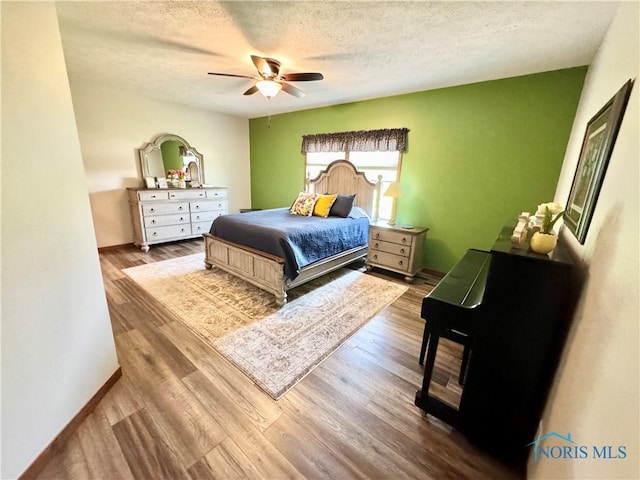 1462 Lee Ann Ave, Defiance, OH 43512 - bedroom with a textured ceiling, wood finished floors, and ceiling fan