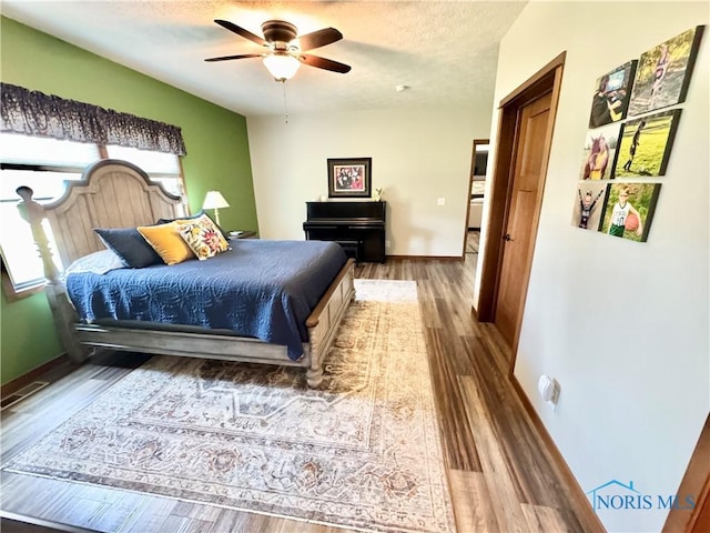 1462 Lee Ann Ave, Defiance, OH 43512 - bedroom featuring wood finished floors, a textured ceiling, and a ceiling fan