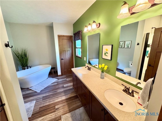 1462 Lee Ann Ave, Defiance, OH 43512 - bathroom featuring wood finished floors, a freestanding bath, and double vanity