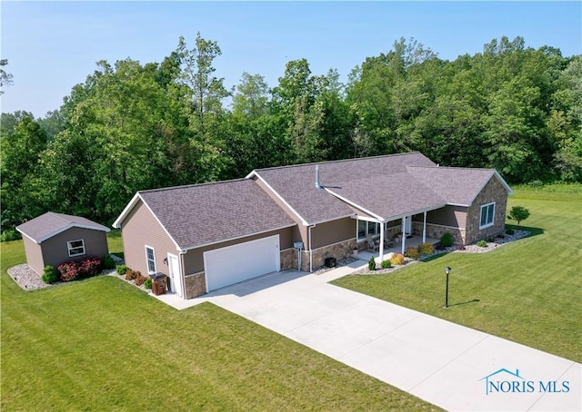 1462 Lee Ann Ave, Defiance, OH 43512 - single story home featuring stone siding, a front lawn, a garage, concrete driveway, and a porch