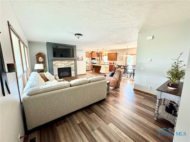 1462 Lee Ann Ave, Defiance, OH 43512 - living area with wood finished floors, a stone fireplace, and a textured ceiling