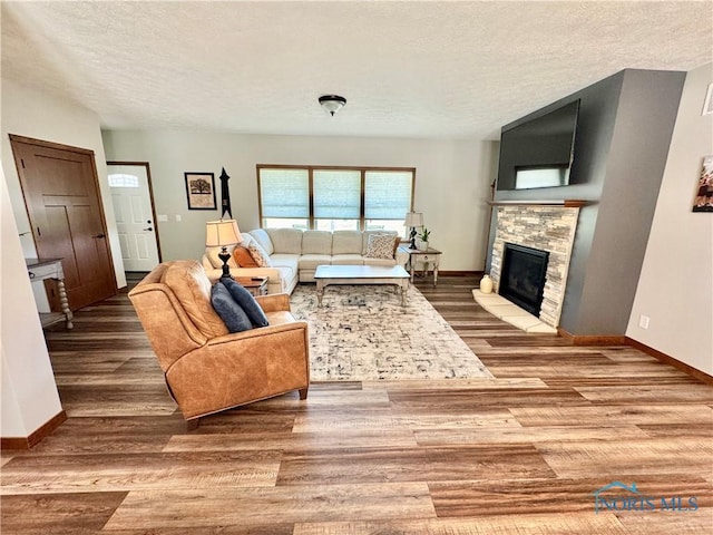 1462 Lee Ann Ave, Defiance, OH 43512 - living area featuring a textured ceiling, wood finished floors, and a fireplace