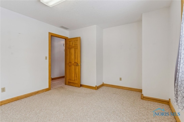 1411 Sawmill Bnd, Findlay, OH 45840 - spare room featuring carpet floors and a textured ceiling