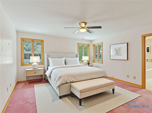 1411 Sawmill Bnd, Findlay, OH 45840 - carpeted bedroom with multiple windows, ensuite bath, and a ceiling fan
