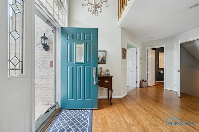 7445 Country Commons Ln Unit 7445, Sylvania, OH 43560 - entrance foyer with healthy amount of natural light, light wood finished floors, and a chandelier