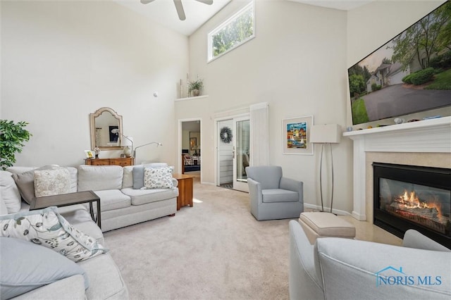 7445 Country Commons Ln Unit 7445, Sylvania, OH 43560 - living room with high vaulted ceiling, a ceiling fan, a glass covered fireplace, and carpet