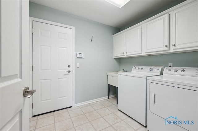 7445 Country Commons Ln Unit 7445, Sylvania, OH 43560 - laundry area featuring cabinet space, separate washer and dryer, and light tile patterned floors