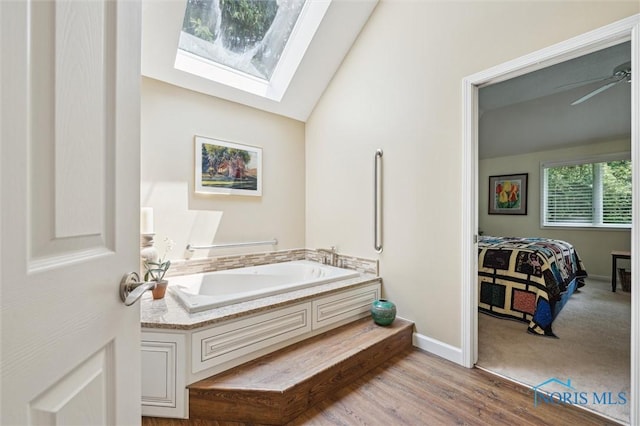7445 Country Commons Ln Unit 7445, Sylvania, OH 43560 - bathroom with a skylight, a garden tub, and vaulted ceiling