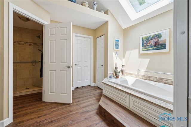 7445 Country Commons Ln Unit 7445, Sylvania, OH 43560 - full bath with a skylight, a shower stall, wood finished floors, a bath, and lofted ceiling