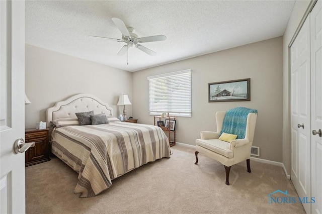 7445 Country Commons Ln Unit 7445, Sylvania, OH 43560 - bedroom featuring a closet, light colored carpet, a ceiling fan, and a textured ceiling