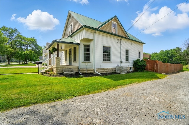 638 W Elm St, Wauseon, OH 43567 - view of side of home with driveway and a metal roof