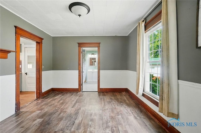 638 W Elm St, Wauseon, OH 43567 - empty room with wood finished floors and crown molding