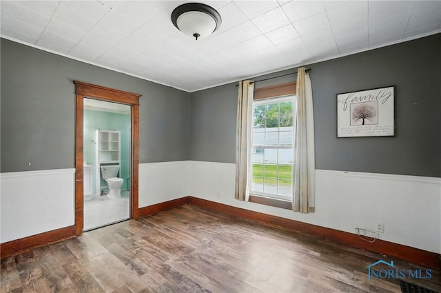 638 W Elm St, Wauseon, OH 43567 - spare room featuring wood finished floors and ornamental molding