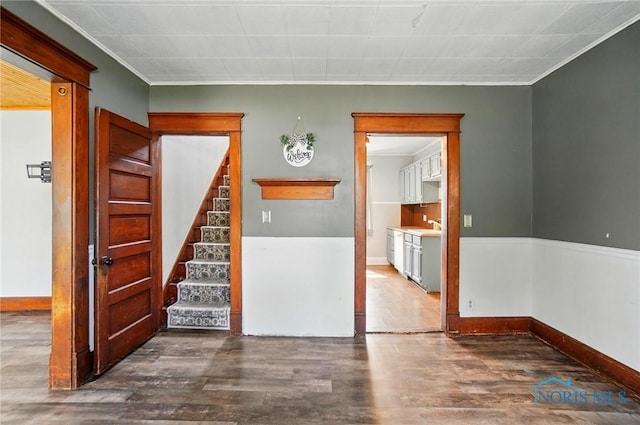 638 W Elm St, Wauseon, OH 43567 - spare room with dark wood-type flooring, crown molding, and stairs