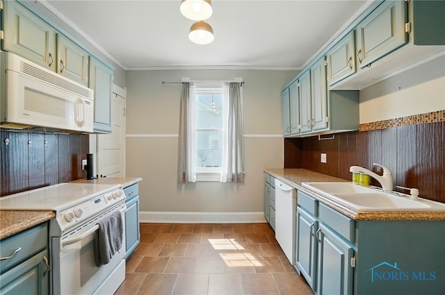 638 W Elm St, Wauseon, OH 43567 - kitchen featuring white appliances, light countertops, blue cabinets, green cabinets, and crown molding