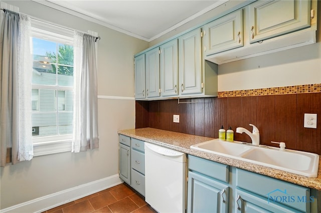 638 W Elm St, Wauseon, OH 43567 - kitchen featuring dishwasher, light countertops, crown molding, dark tile patterned floors, and a wainscoted wall