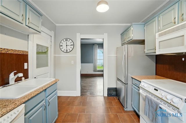 638 W Elm St, Wauseon, OH 43567 - kitchen featuring white appliances, blue cabinets, ornamental molding, and light countertops