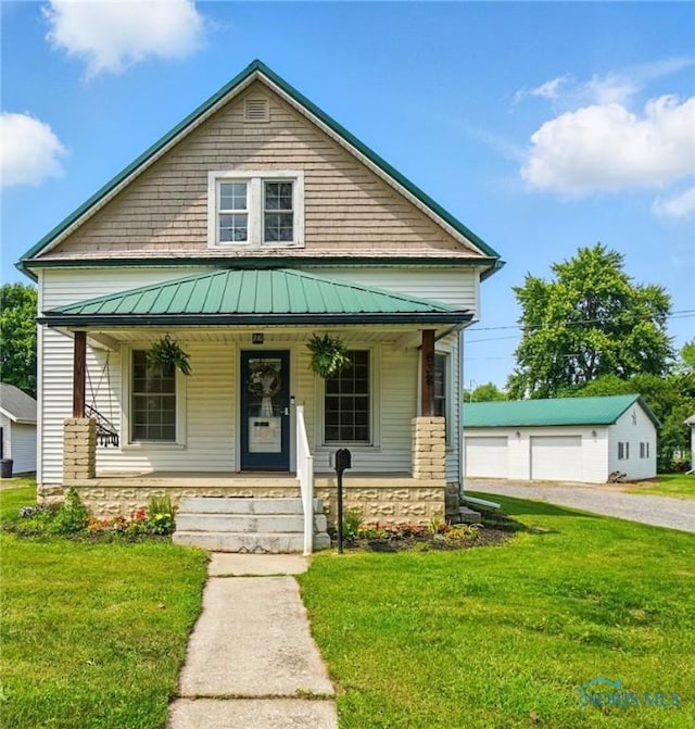 638 W Elm St, Wauseon, OH 43567 - view of front of home featuring covered porch, a standing seam roof, and a front yard