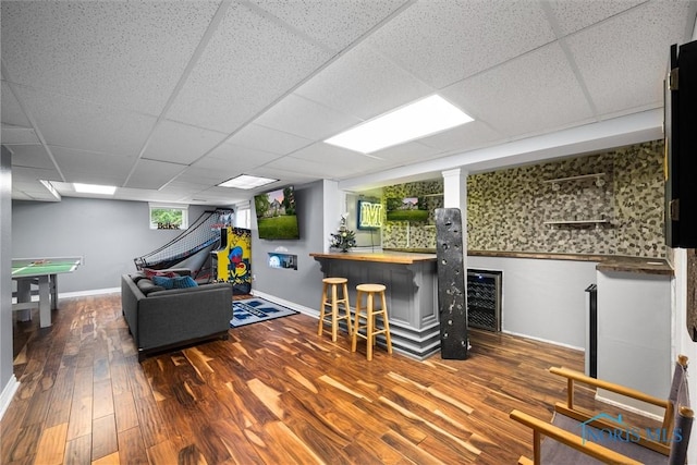 7910 Quail Creek Rd, Maumee, OH 43537 - living area featuring a dry bar, wood finished floors, a paneled ceiling, and wine cooler