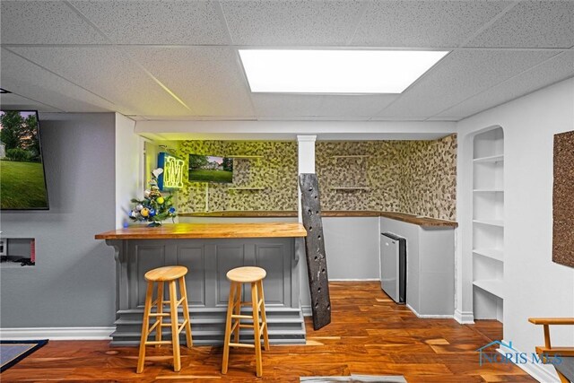 7910 Quail Creek Rd, Maumee, OH 43537 - indoor dry bar with wood finished floors and a paneled ceiling