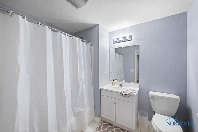 7910 Quail Creek Rd, Maumee, OH 43537 - full bathroom with vanity, tile patterned flooring, a textured ceiling, and curtained shower