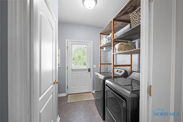 7910 Quail Creek Rd, Maumee, OH 43537 - laundry room with washing machine and clothes dryer and dark tile patterned floors