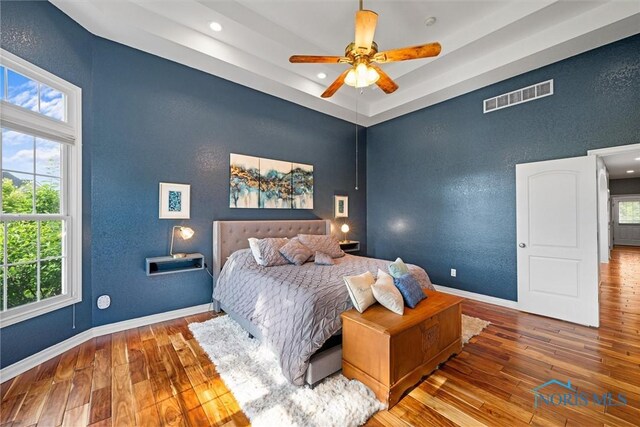 7910 Quail Creek Rd, Maumee, OH 43537 - bedroom with wood-type flooring, multiple windows, recessed lighting, and a ceiling fan