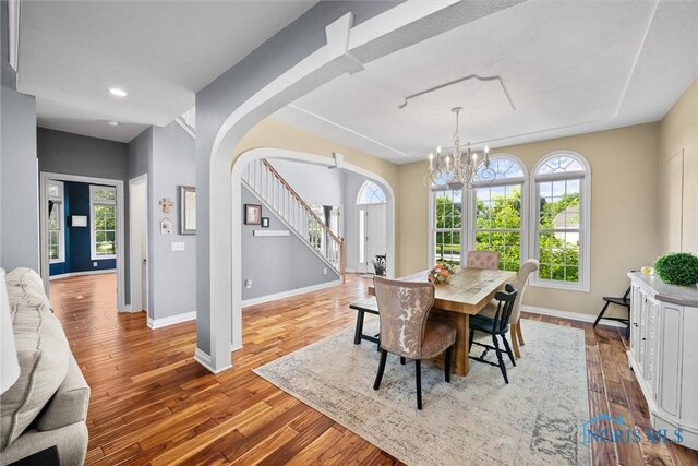 7910 Quail Creek Rd, Maumee, OH 43537 - dining space featuring arched walkways, a chandelier, plenty of natural light, and recessed lighting