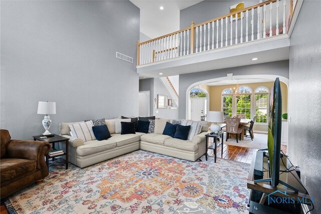 7910 Quail Creek Rd, Maumee, OH 43537 - living area with arched walkways, wood finished floors, a high ceiling, and recessed lighting