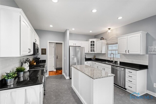 7910 Quail Creek Rd, Maumee, OH 43537 - kitchen featuring appliances with stainless steel finishes, white cabinetry, backsplash, a center island, and recessed lighting